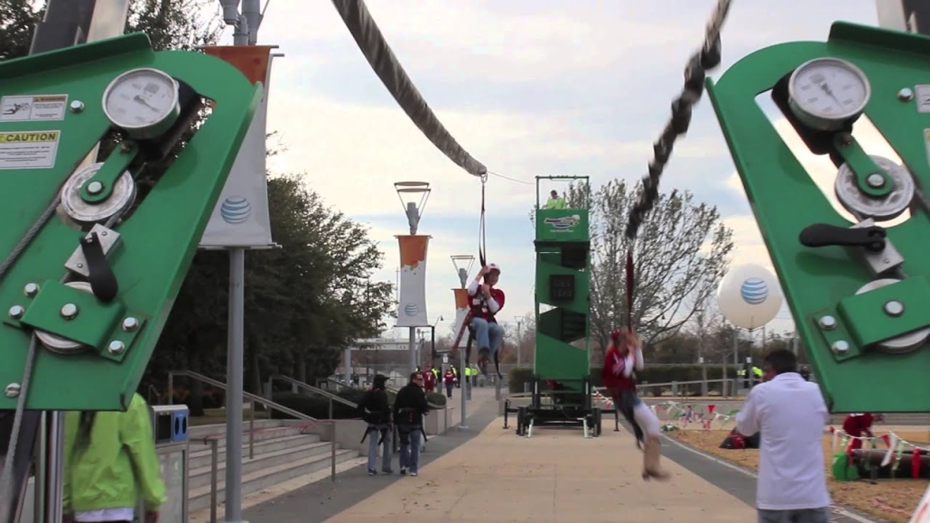 Adventurous teenagers enjoying a thrilling zip line ride through an outdoor park area